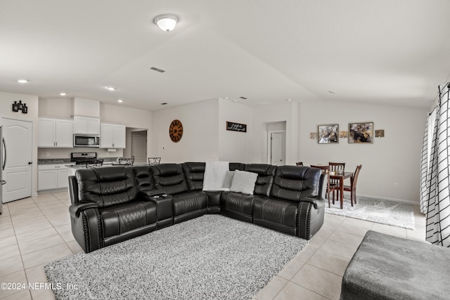 living room with light tile patterned flooring and lofted ceiling