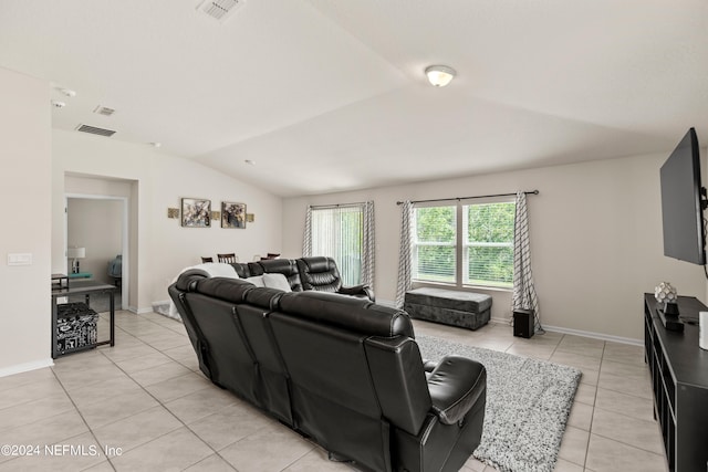 living room with light tile patterned floors and lofted ceiling