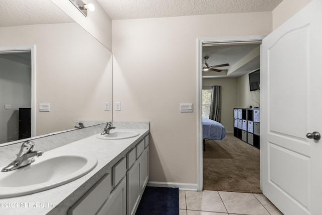 bathroom with tile patterned flooring, vanity, a textured ceiling, and ceiling fan