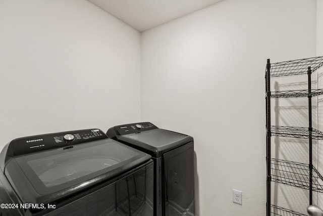 clothes washing area with separate washer and dryer