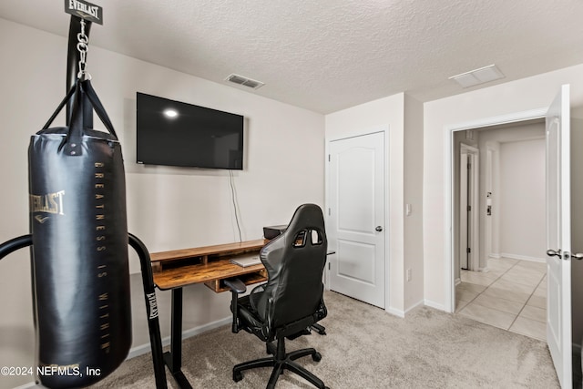 carpeted office space with a textured ceiling