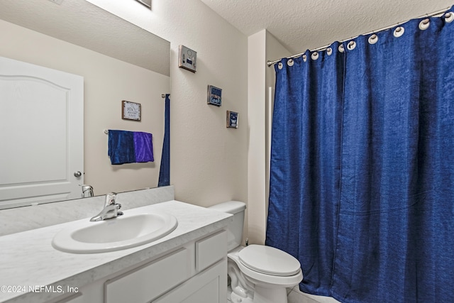 bathroom featuring vanity, toilet, and a textured ceiling