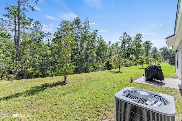 view of yard featuring a patio area and central AC