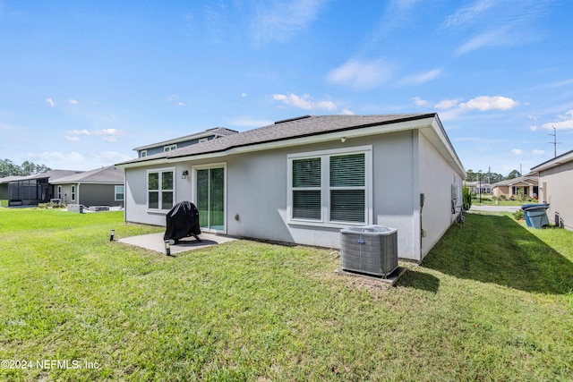 rear view of house featuring a yard, a patio, and central AC unit