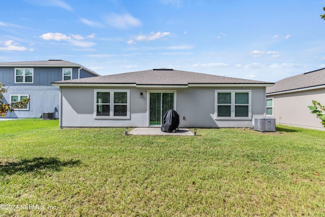 rear view of property with a yard, a patio, and central AC unit