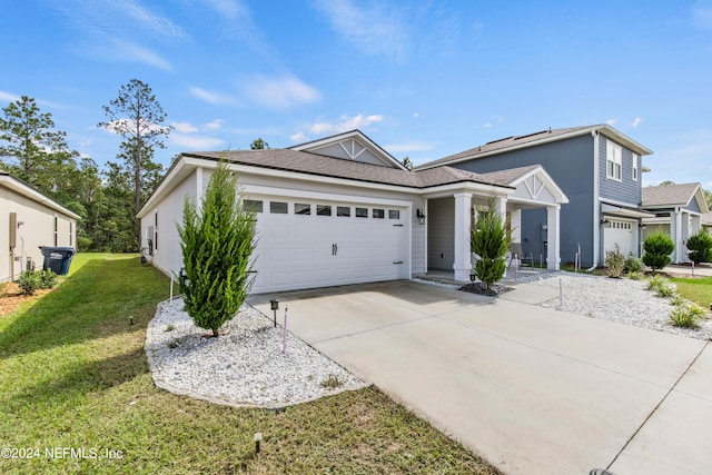 view of front of property featuring a garage and a front lawn