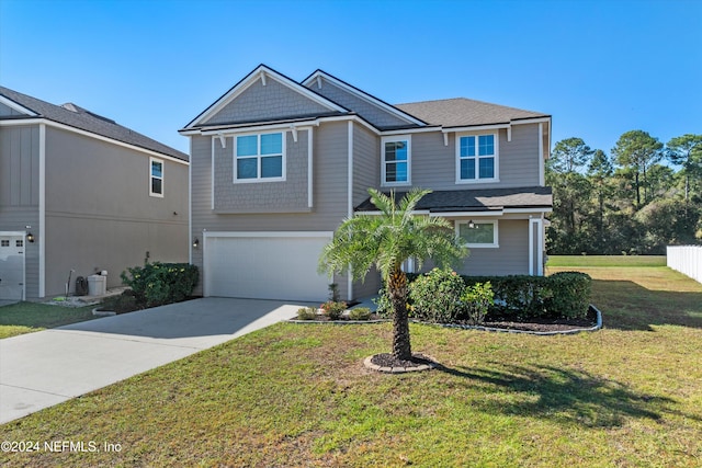 view of front of house with a garage and a front yard