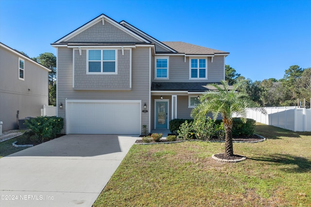 view of front of home with a front yard and a garage