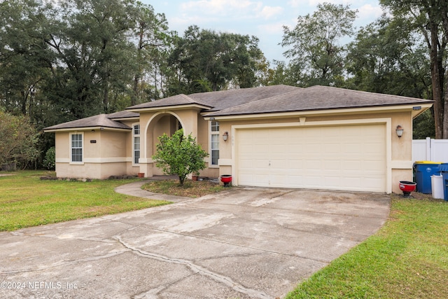 view of front of property featuring a front yard and a garage