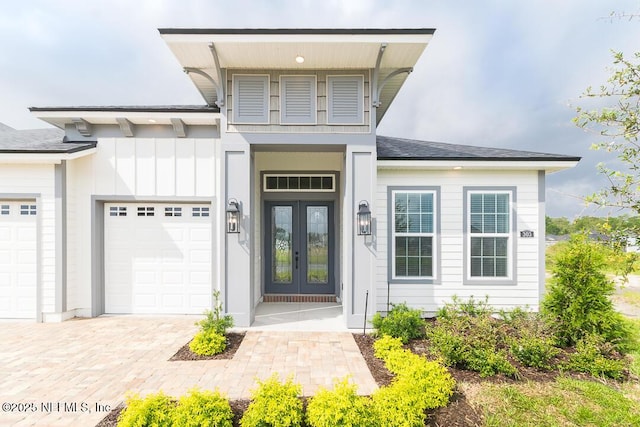 view of front of house with a garage and french doors