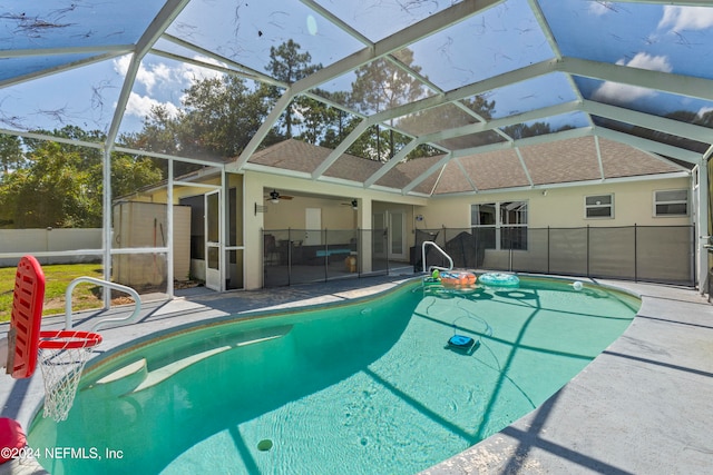 view of pool featuring a patio, ceiling fan, and a lanai