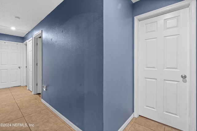 corridor featuring light tile patterned flooring