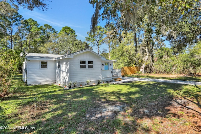 rear view of property with a lawn