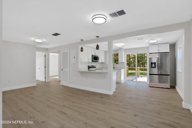 kitchen featuring kitchen peninsula, light hardwood / wood-style floors, white cabinetry, and stainless steel appliances