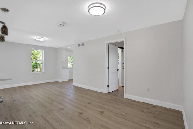 unfurnished room with light wood-type flooring