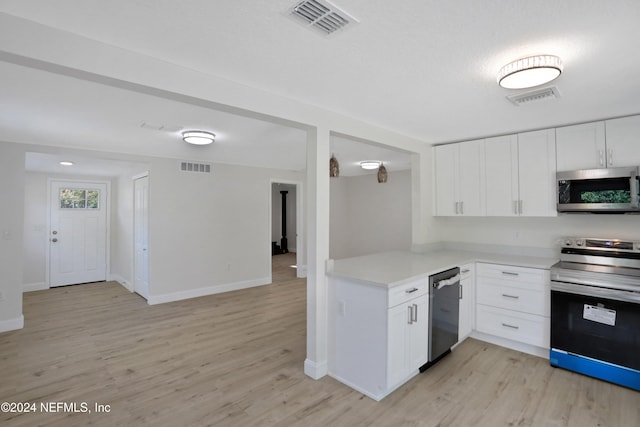 kitchen with white cabinetry, stainless steel appliances, and light wood-type flooring