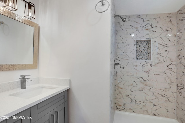 bathroom with vanity and tiled shower / bath combo