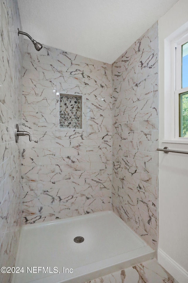 bathroom with a tile shower