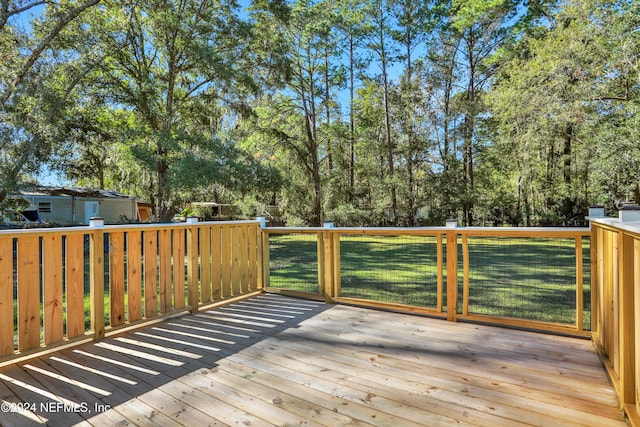 wooden terrace with a lawn