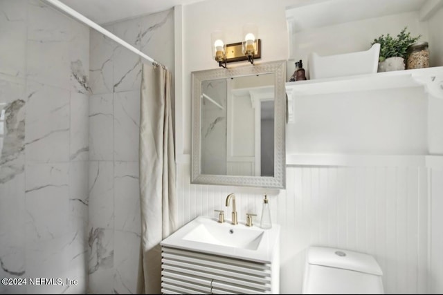 bathroom featuring vanity, toilet, and walk in shower