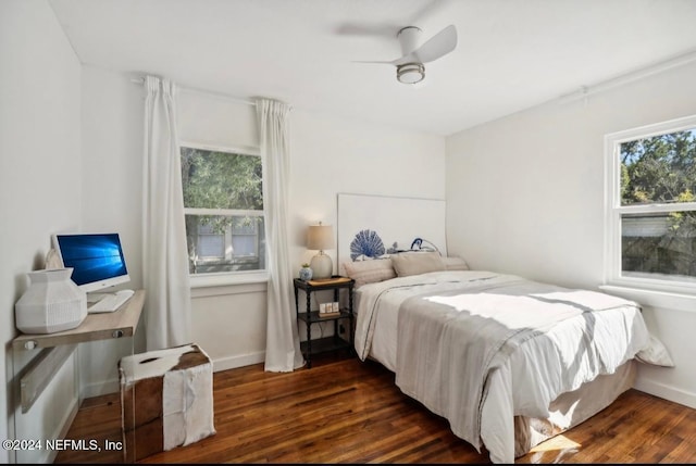 bedroom with dark hardwood / wood-style floors and ceiling fan