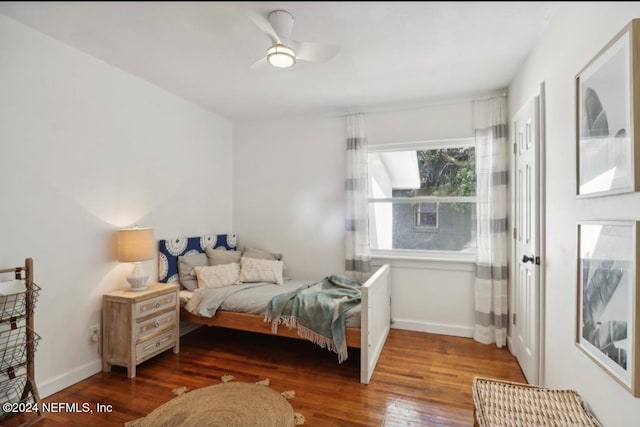 bedroom with ceiling fan and dark wood-type flooring