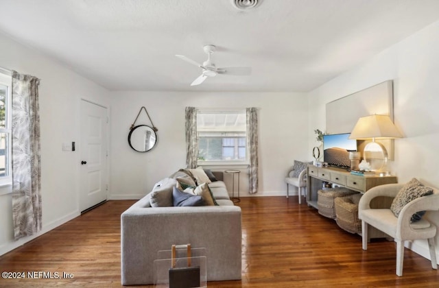 living room with ceiling fan and dark hardwood / wood-style flooring