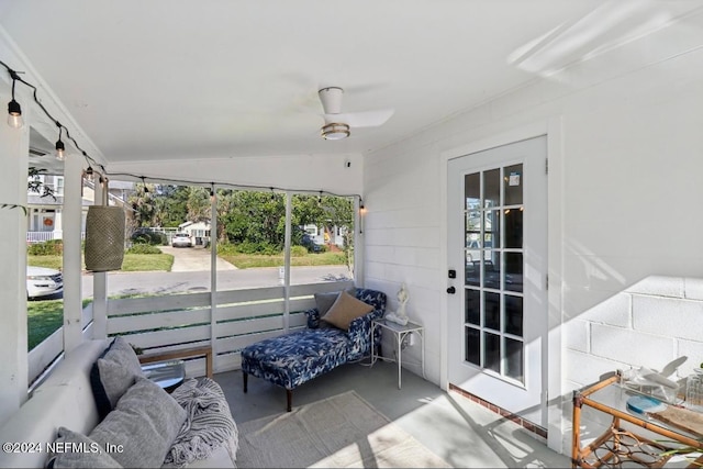 sunroom / solarium featuring ceiling fan and lofted ceiling