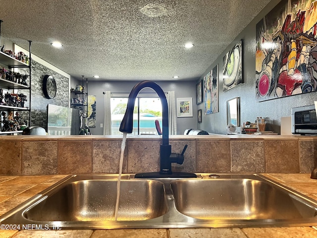 650 Pope Rd W Unit 251, Saint Augustine, FL 32080 - detailed view of a sink, a textured ceiling, tile countertops, and recessed lighting