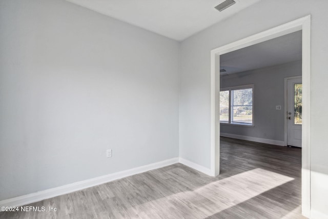 unfurnished room with hardwood / wood-style floors