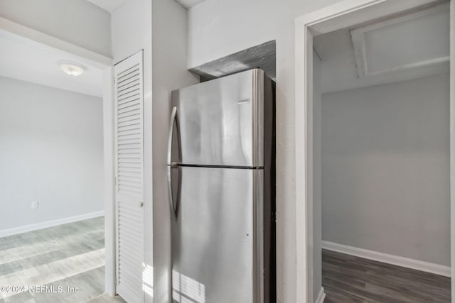 kitchen with hardwood / wood-style floors and stainless steel refrigerator