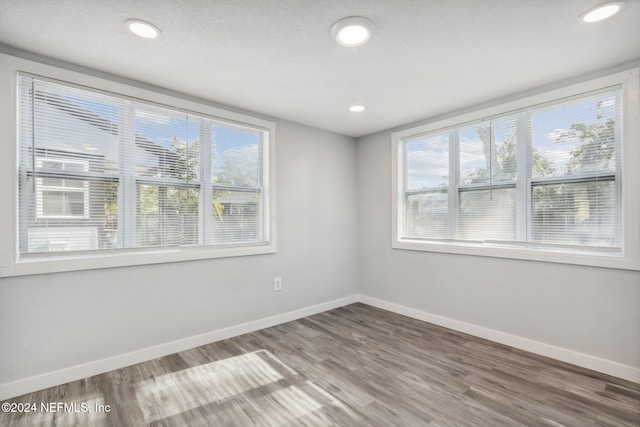 unfurnished room featuring hardwood / wood-style flooring