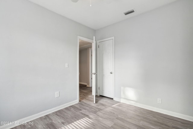 spare room featuring light hardwood / wood-style flooring and ceiling fan