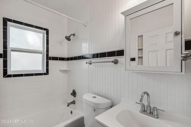 full bathroom featuring vanity, toilet, and tiled shower / bath