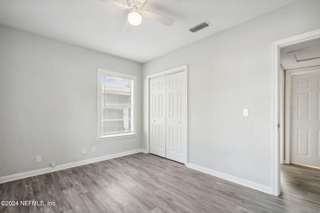 unfurnished bedroom featuring ceiling fan, a closet, and light hardwood / wood-style floors