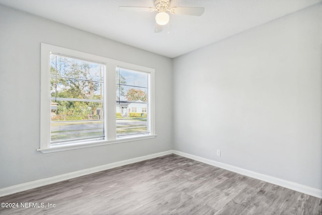 empty room with hardwood / wood-style flooring and ceiling fan