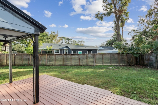 wooden terrace with a yard