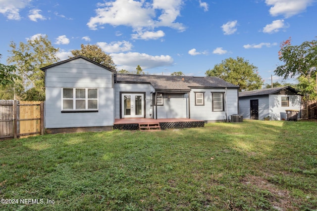 back of property featuring french doors, a yard, a deck, and central air condition unit