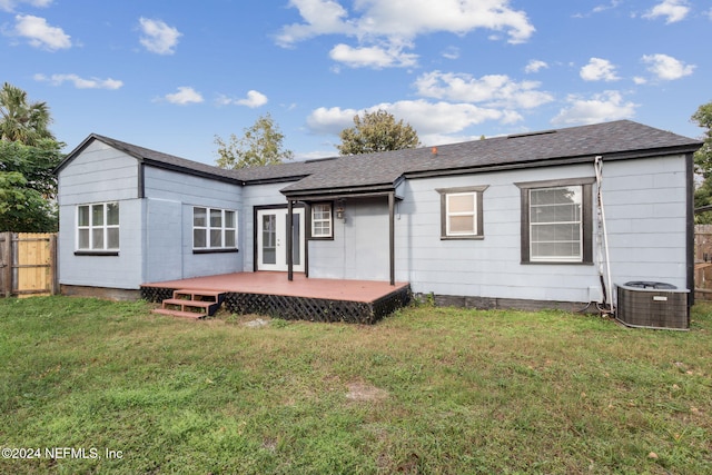 back of house featuring a lawn, central AC unit, and a deck