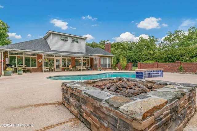 7436 Woodlawn Rd, Macclenny, FL 32063 - view of swimming pool with a patio and a fire pit