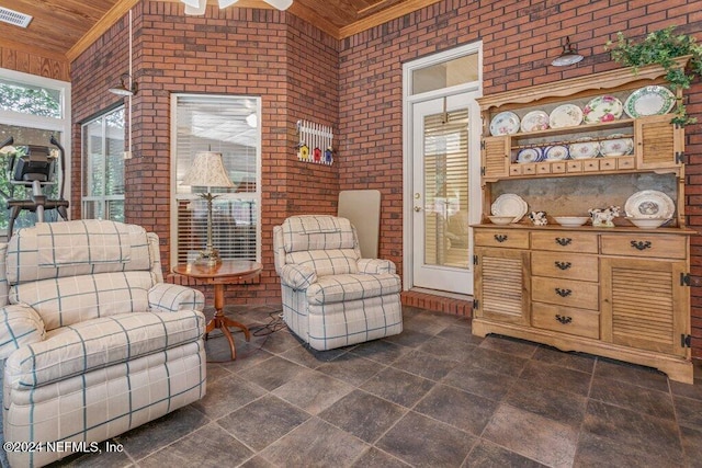 7436 Woodlawn Rd, Macclenny, FL 32063 - living area with ceiling fan, wood ceiling, ornamental molding, and brick wall