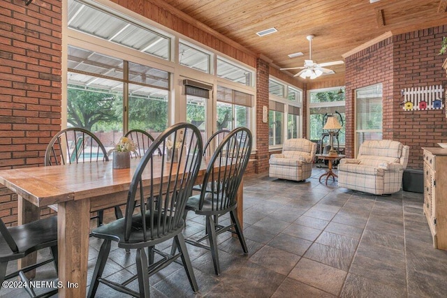 7436 Woodlawn Rd, Macclenny, FL 32063 - dining area with ceiling fan, wood ceiling, and brick wall