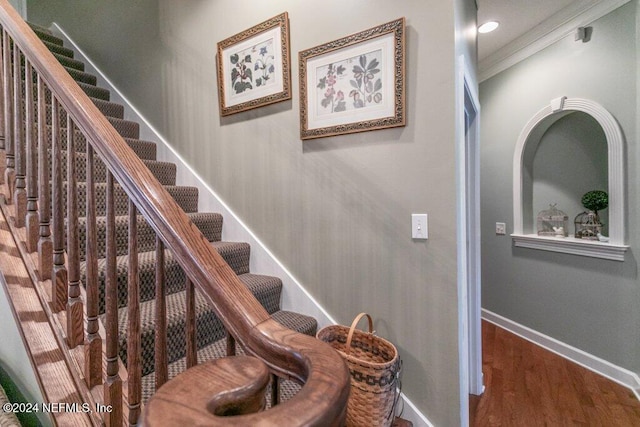 7436 Woodlawn Rd, Macclenny, FL 32063 - stairway featuring wood-type flooring and crown molding