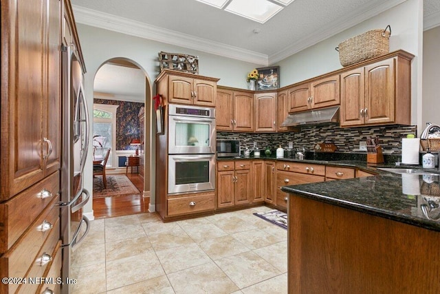 7436 Woodlawn Rd, Macclenny, FL 32063 - kitchen featuring sink, dark stone countertops, decorative backsplash, appliances with stainless steel finishes, and ornamental molding