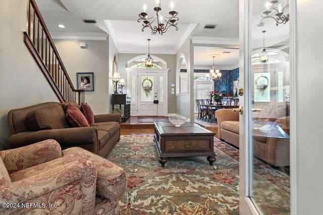 7436 Woodlawn Rd, Macclenny, FL 32063 - living room featuring crown molding, dark wood-type flooring, and an inviting chandelier