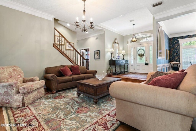 7436 Woodlawn Rd, Macclenny, FL 32063 - living room with ornamental molding, a notable chandelier, and wood-type flooring