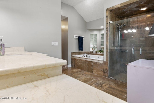7436 Woodlawn Rd, Macclenny, FL 32063 - bathroom featuring a textured ceiling, vaulted ceiling, and independent shower and bath