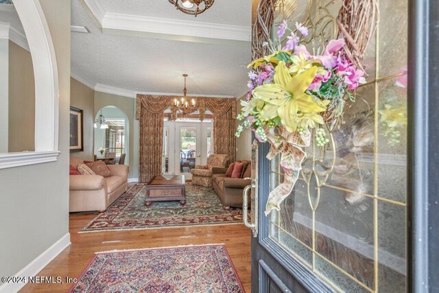 7436 Woodlawn Rd, Macclenny, FL 32063 - living room with hardwood / wood-style flooring, ornamental molding, a textured ceiling, and a chandelier