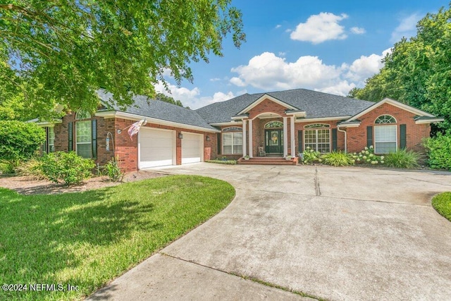 7436 Woodlawn Rd, Macclenny, FL 32063 - ranch-style home with a garage and a front yard