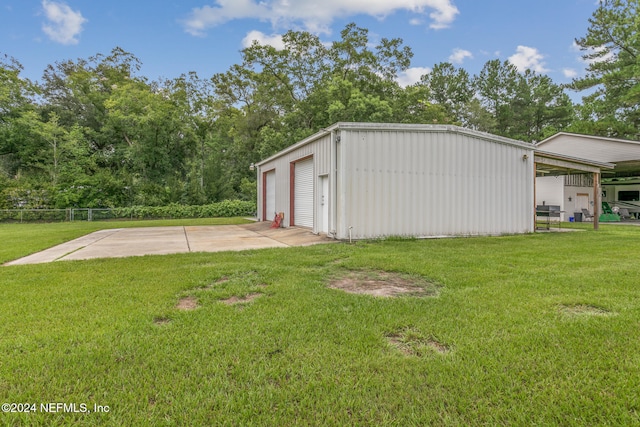 7436 Woodlawn Rd, Macclenny, FL 32063 - view of outbuilding with a lawn and a garage